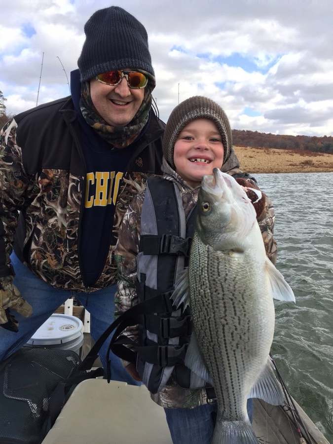 Aaron, about seven, with a hybrid striped bass. The oldest photo we have.