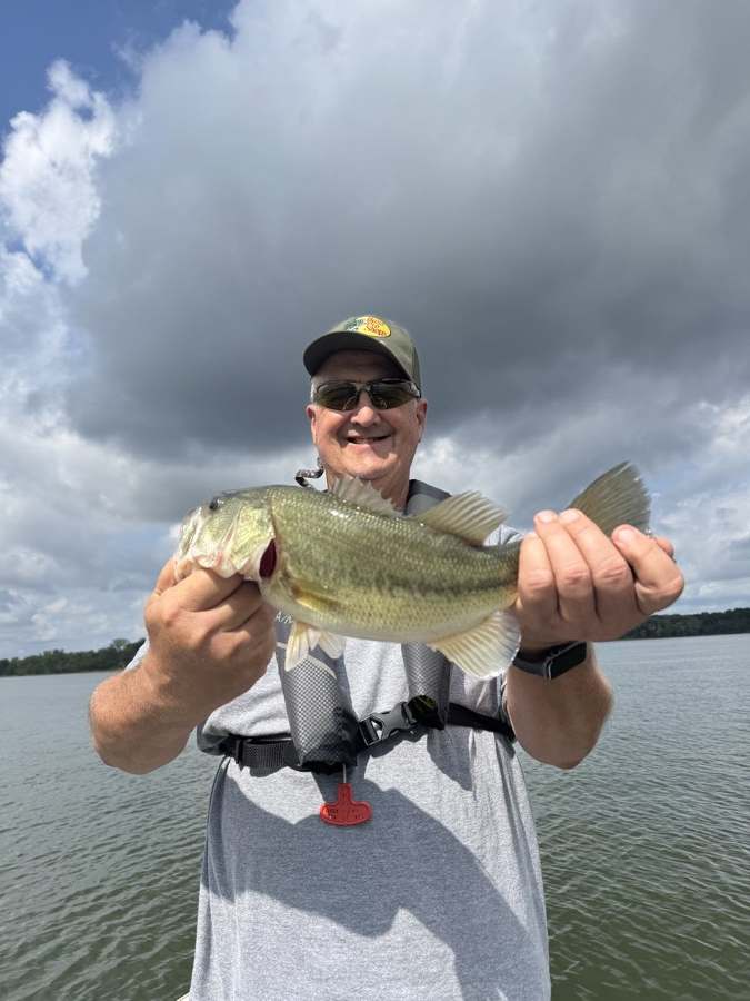 Two pounds off a long point where a creek drops into the river channel — a Texas-rigged purple worm, after six other spots blanked on the same bait.